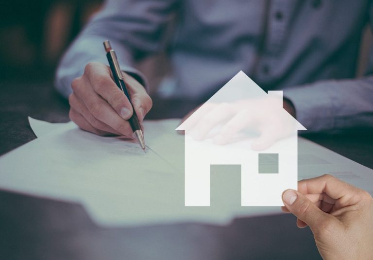Signing a mortgage contract A guy is signing a mortgage contract for the new house